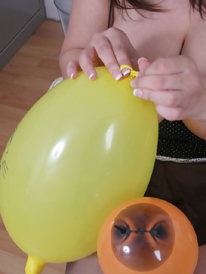 Board top-heavy girl at work playing with balloons