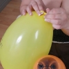Board busty girl at work playing with balloons